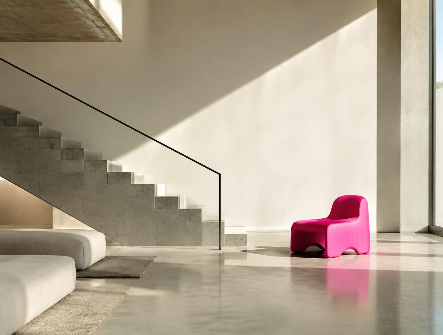 Minimal concrete and warm white interior with a single hot pink chair